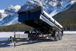 High-quality hero shot of the SL714-14K dump trailer in a raised position against a snow-capped mountain backdrop.