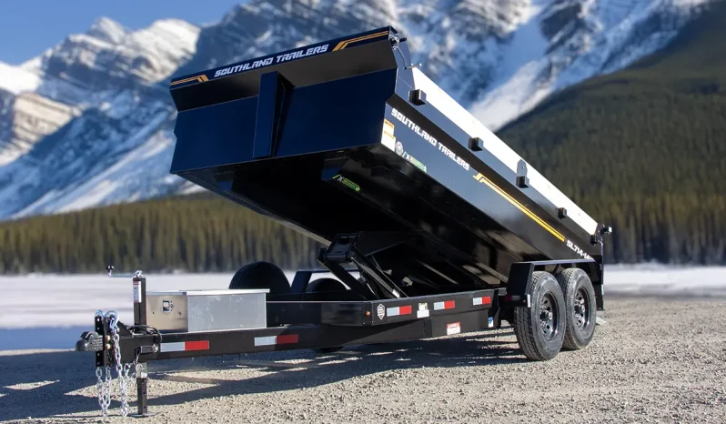 High-quality hero shot of the SL714-14K dump trailer in a raised position against a snow-capped mountain backdrop.